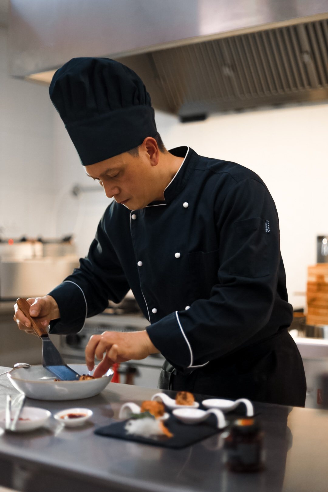 Chef Enrico plating a dish in the Kultura kitchen