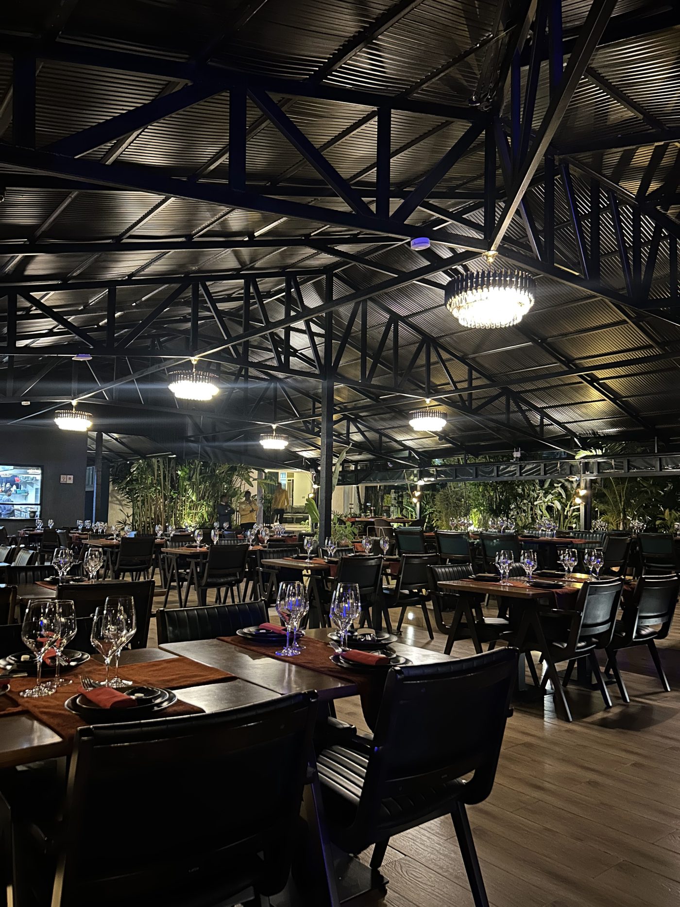 The main dining hall under steel trusses and chandeliers